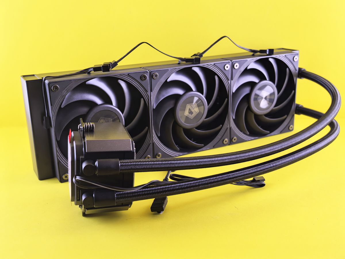 Triple fan liquid cooling system for efficient PC cooling on bright yellow background.
