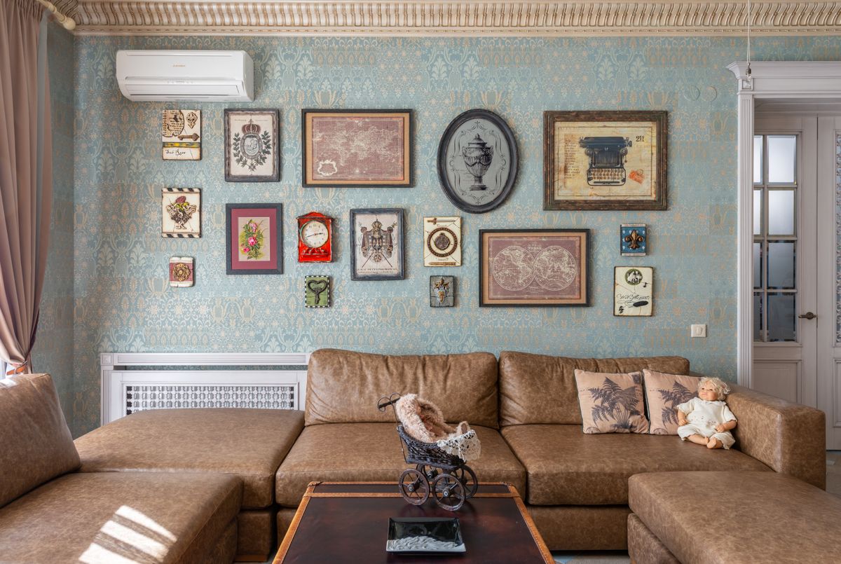 Interior of retro lounge room with comfortable sofa around wooden table with ornamental elements near ceiling