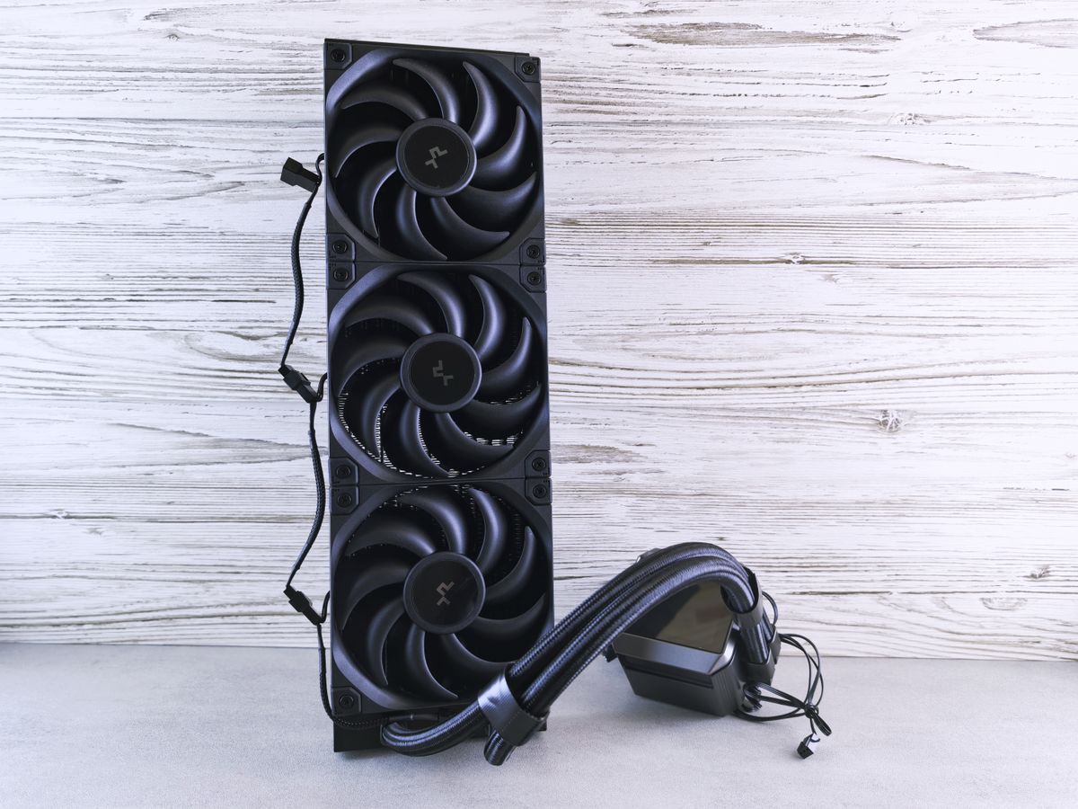 A triple fan radiator setup with cables, ideal for PC cooling solutions in a modern setting.