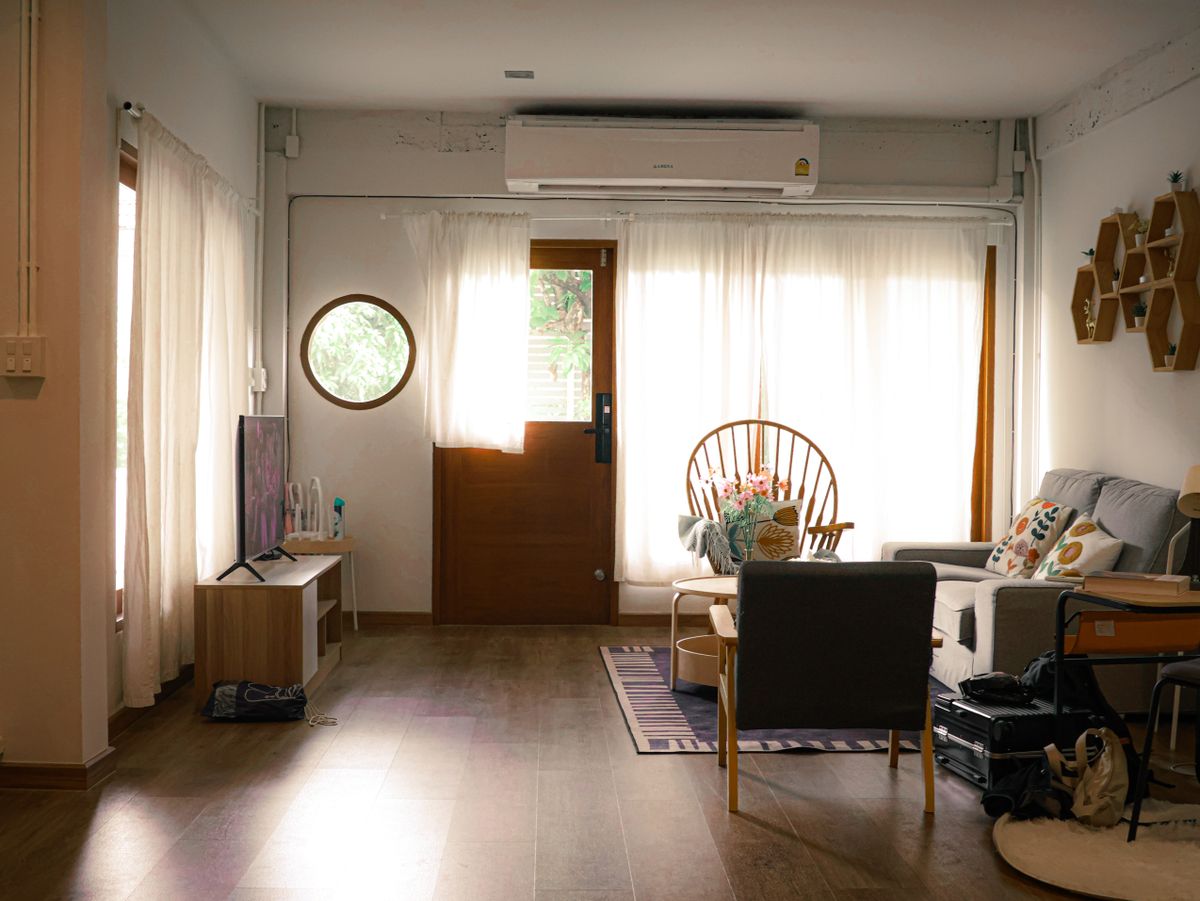 Bright and comfortable living room interior in Bangkok with natural light and modern furniture.