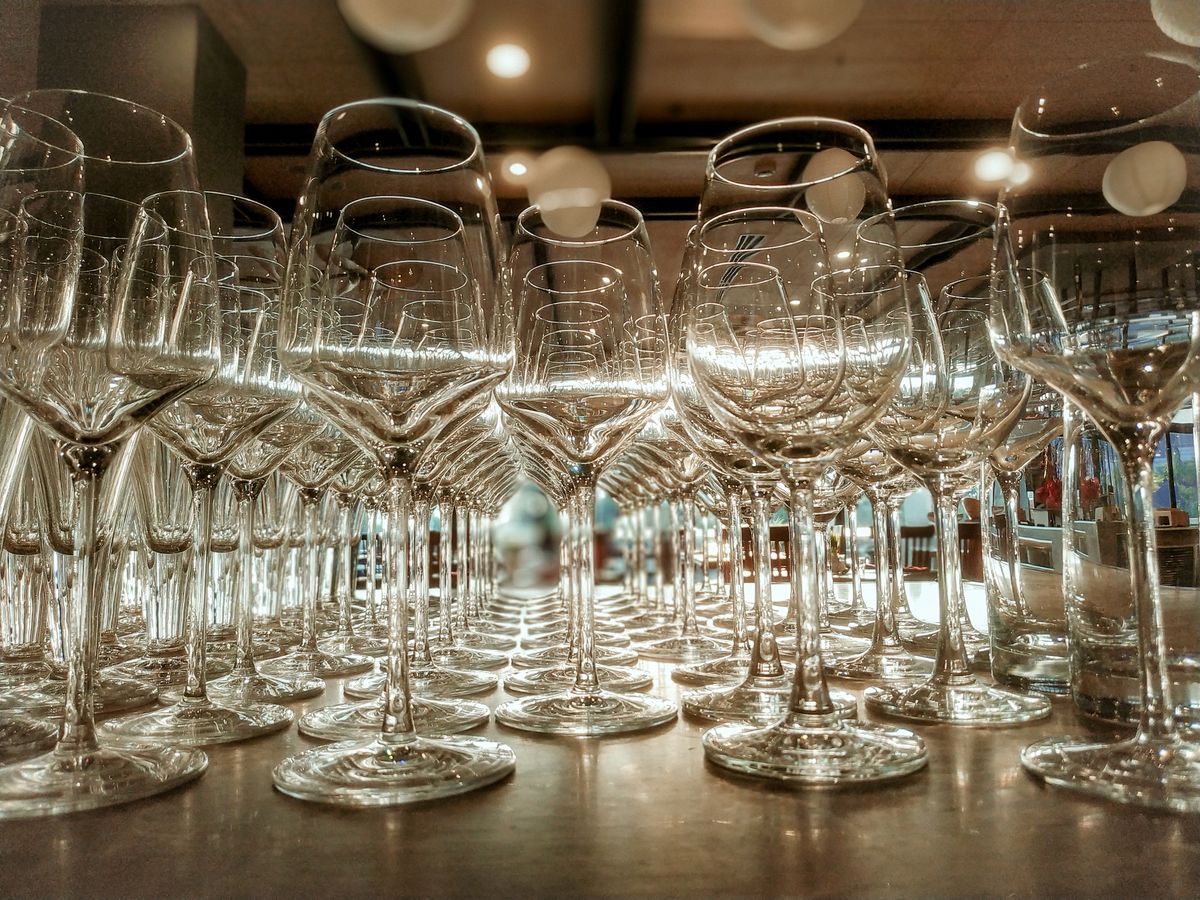 Crystal-clear wine glasses beautifully arranged on a restaurant table, reflecting elegance and sophistication.