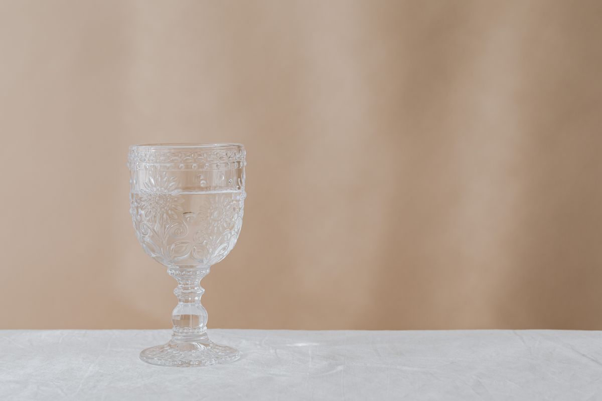 Close-up of a decorative glass goblet on a table, perfect for minimalist designs.