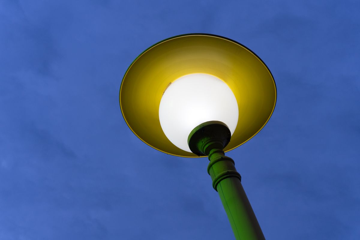 Bright street lamp in Baku, Azerbaijan, glowing warmly against the evening sky.