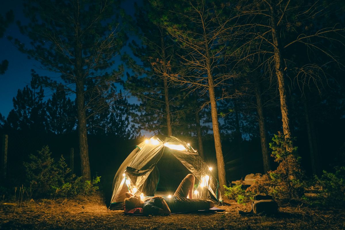 A serene camping scene in Konya, Turkey with a tent lit under a starry night sky.