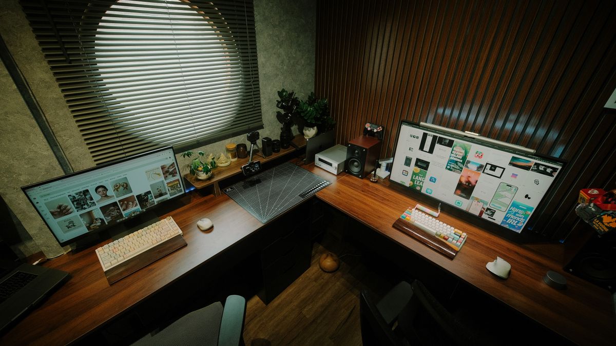 Stylish home office with dual monitors, wooden desk, and tech gadgets. Ideal for productivity.