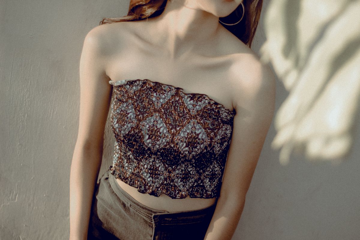 Portrait of a woman in a strapless top with elegant lighting, perfect for fashion or lifestyle themes.