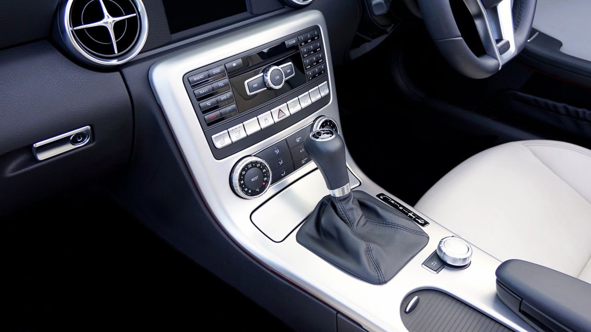 Elegant black and white car interior focusing on gearshift and controls.
