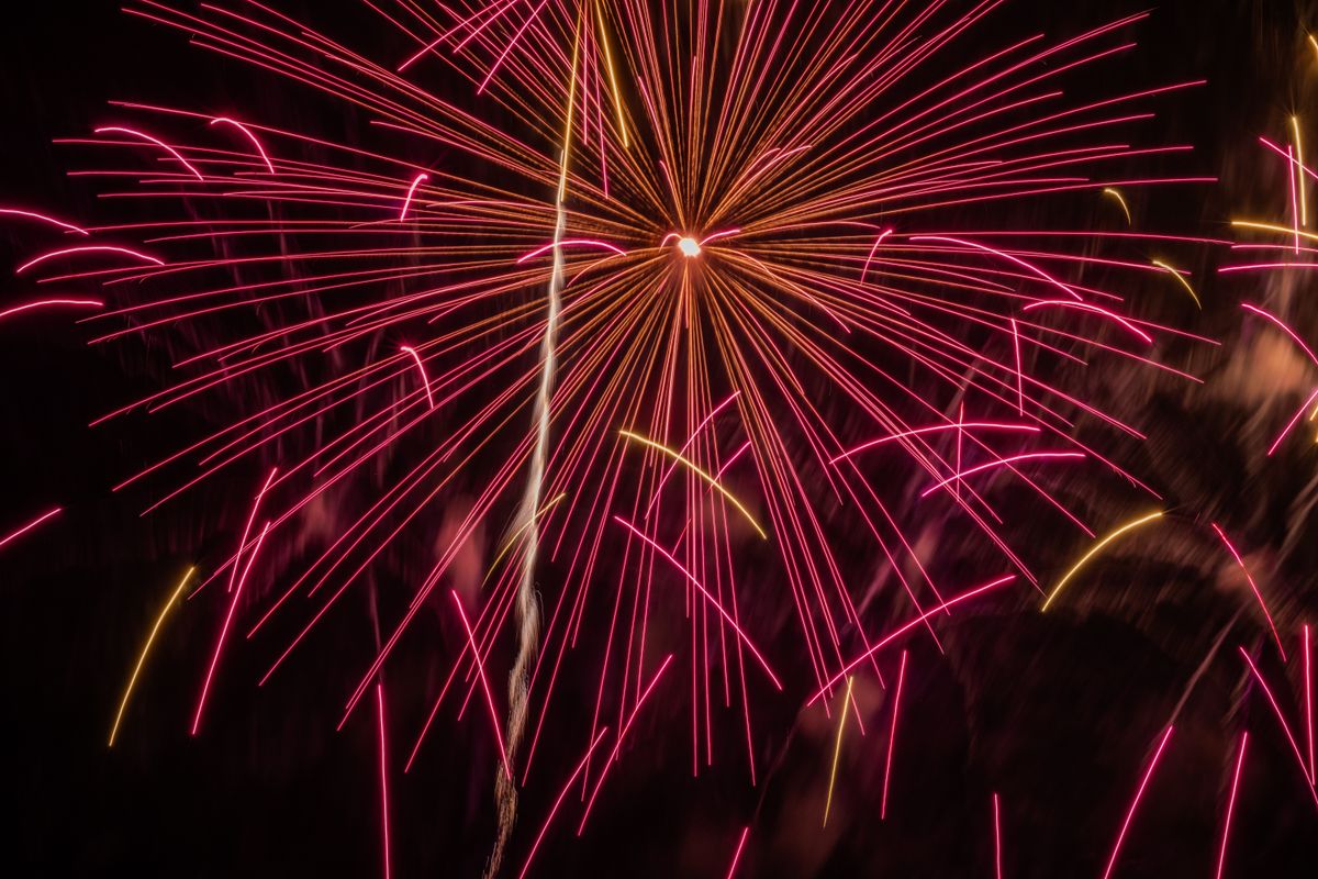 Colorful fireworks illuminate the night sky with a spectacular burst of light.