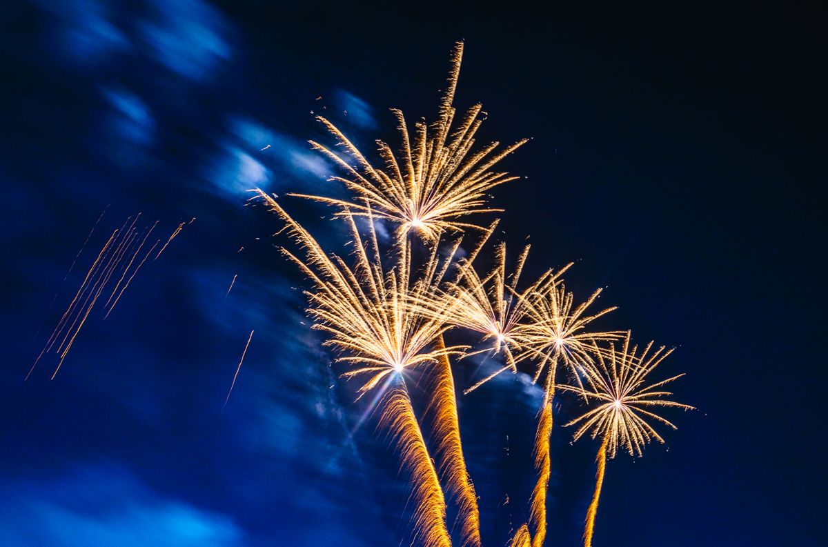 Bright fireworks lighting up the night sky with vibrant colors and patterns.