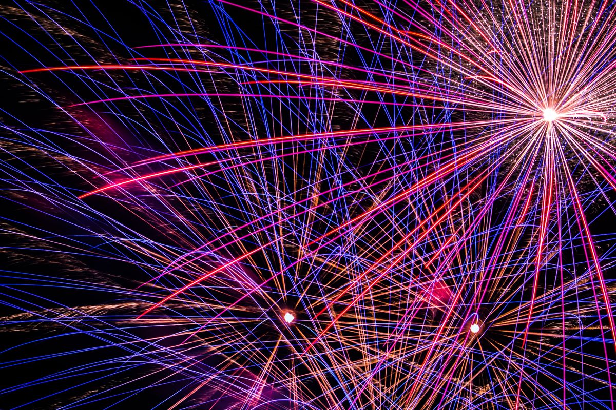 Vibrant fireworks display lighting up the night sky with colorful streaks and bursts of light.