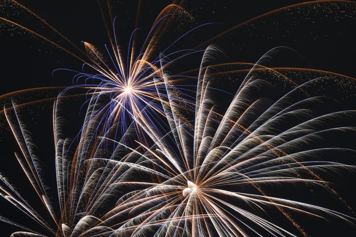 A vivid fireworks display lighting up the dark night sky with vibrant colors and patterns.