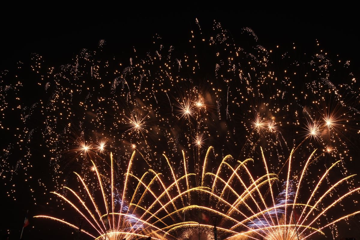 A dazzling display of fireworks lighting up the night sky in vibrant colors.