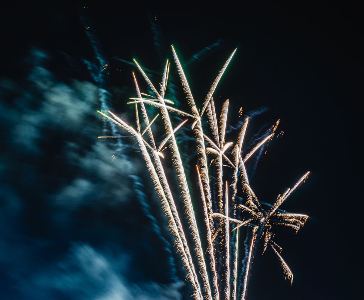 A dazzling fireworks burst lighting up the night sky during a festive event.