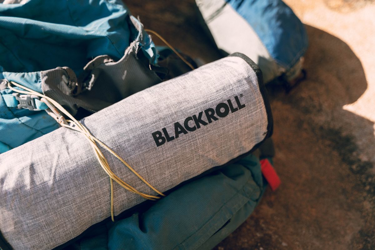 Close-up of hiking equipment featuring a Blackroll accessory, perfect for outdoor adventures.