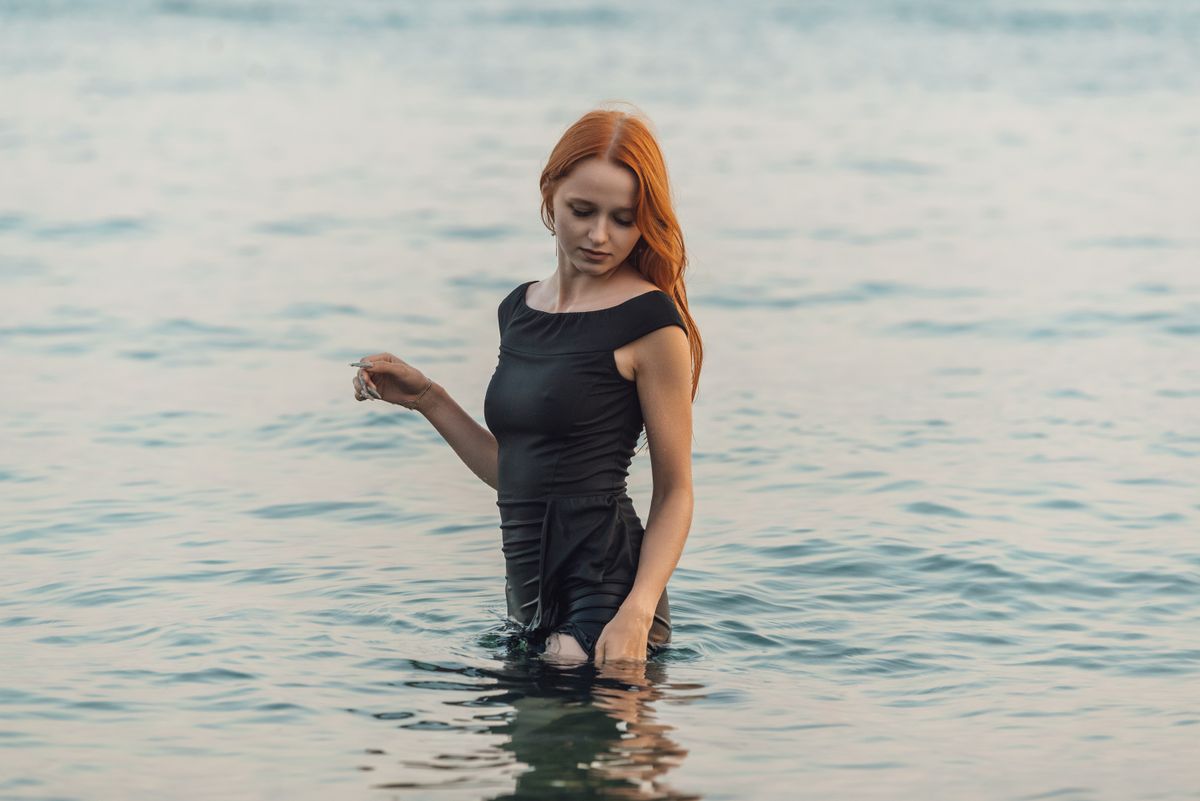 A serene moment captured in Gagra as a young woman enjoys a calm swim. Perfect for relaxation themes.
