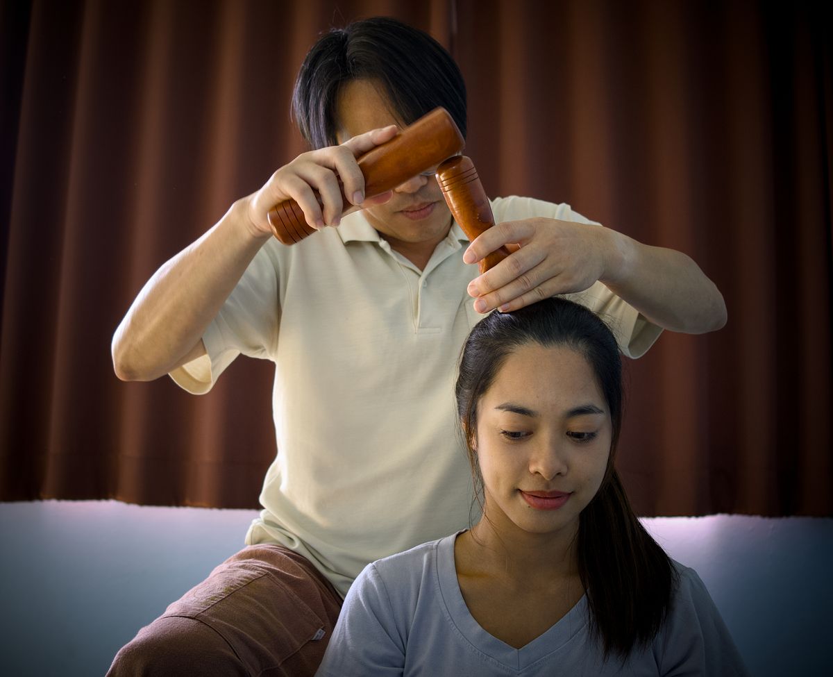 Experience deep relaxation with a traditional Thai wooden tool massage in Chiang Mai spa.