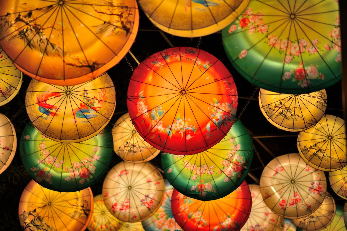 Colorful decorative lanterns create a vibrant atmosphere during an Asian lantern festival at night.
