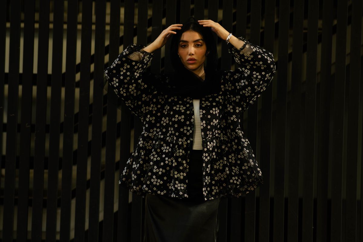 Portrait of a Middle Eastern woman in floral attire, showcasing elegance and style in Tehran.