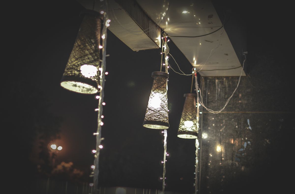 Decorative hanging lamps illuminated at night, showcasing creative lighting design in Ahmedabad, India.