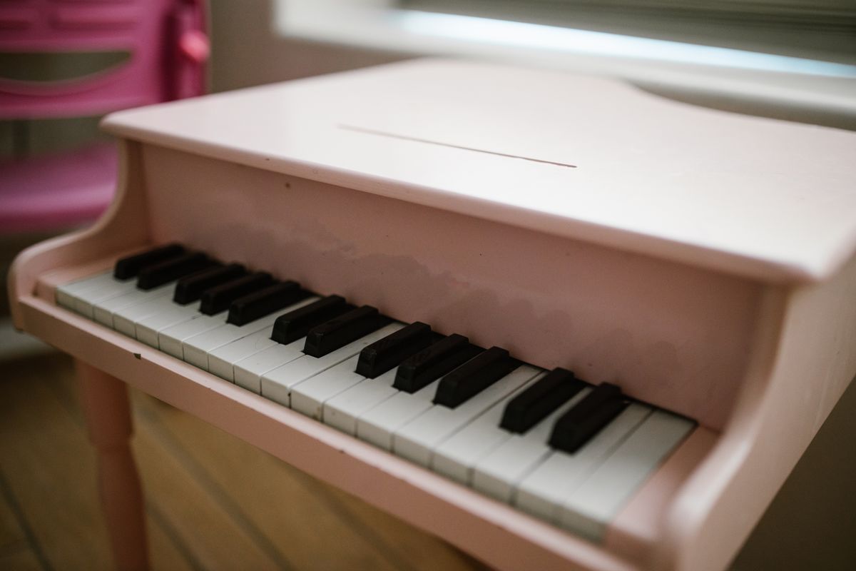 Charming close-up of a pink toy piano perfect for music-themed children's room decor.