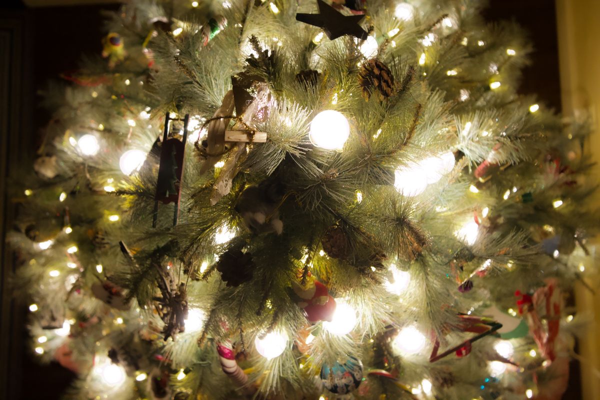 Festive Christmas tree adorned with glowing lights and ornaments, creating a warm holiday ambiance.