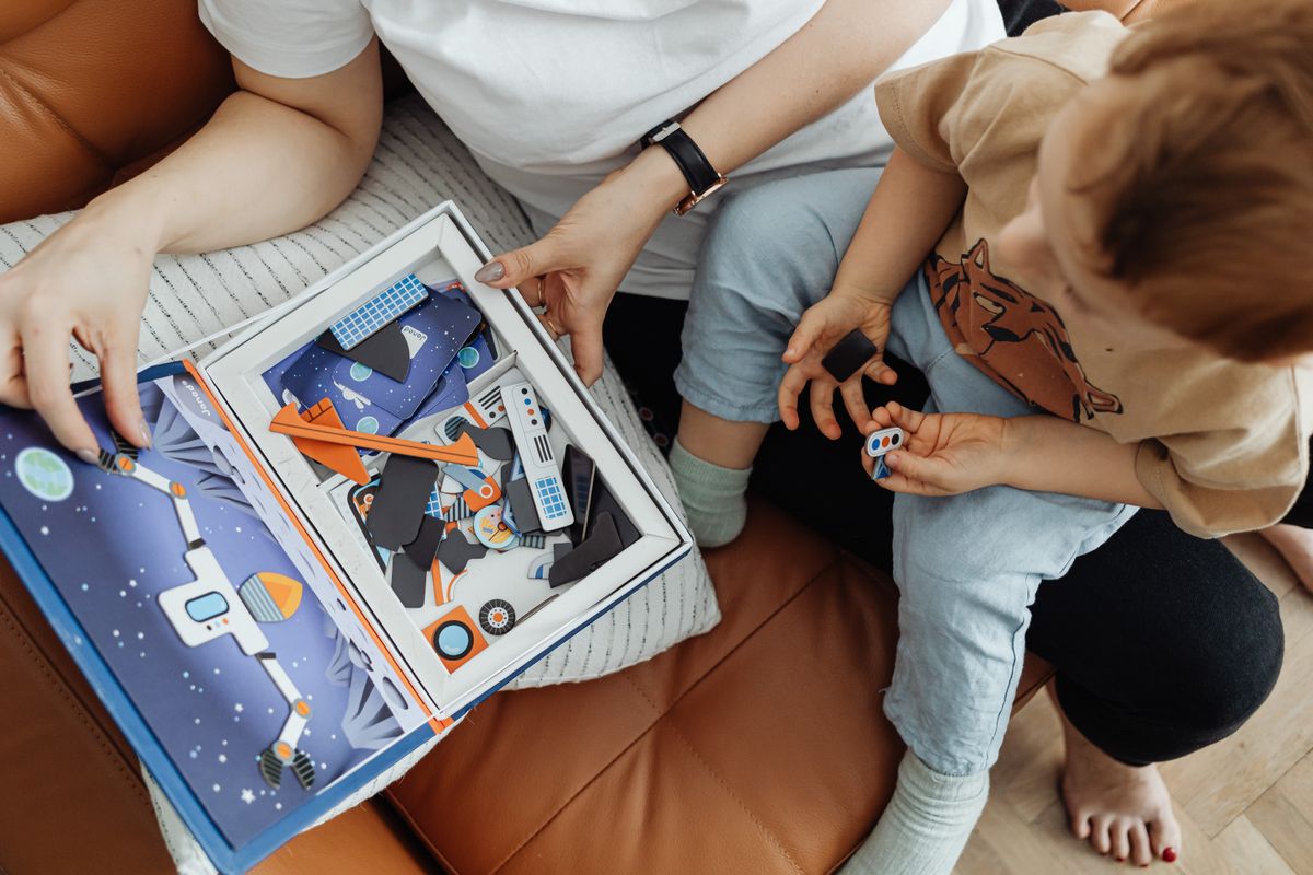 A mother and child enjoying a colorful puzzle activity together indoors.
