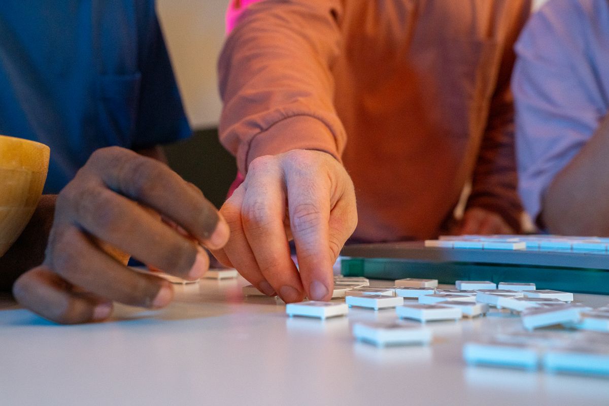 Two friends engaged in a fun board game, emphasizing bonding and interaction.