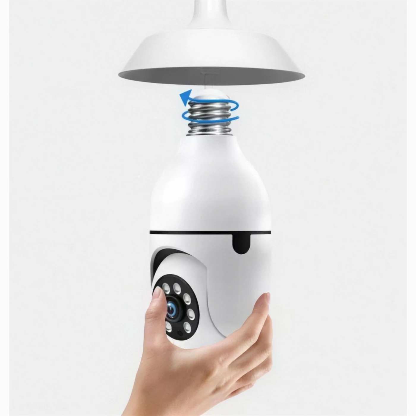A hand screwing the bulb camera into a ceiling light fixture