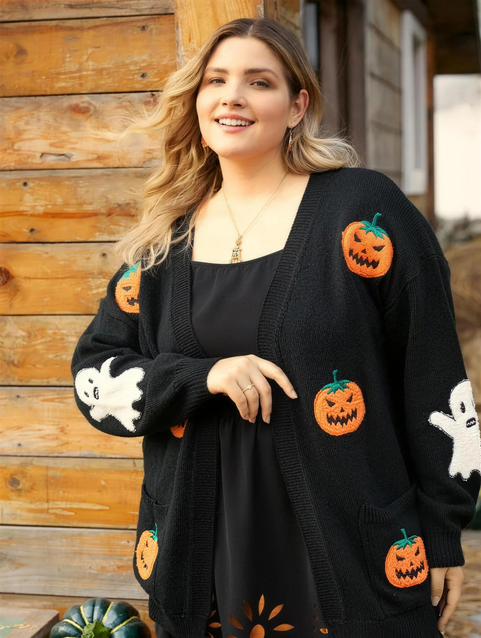 Pumpkin cardigan worn open over a black top