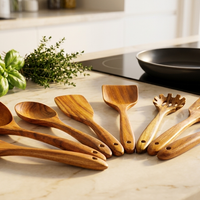 Teak utensils on a kitchen counter by the stove