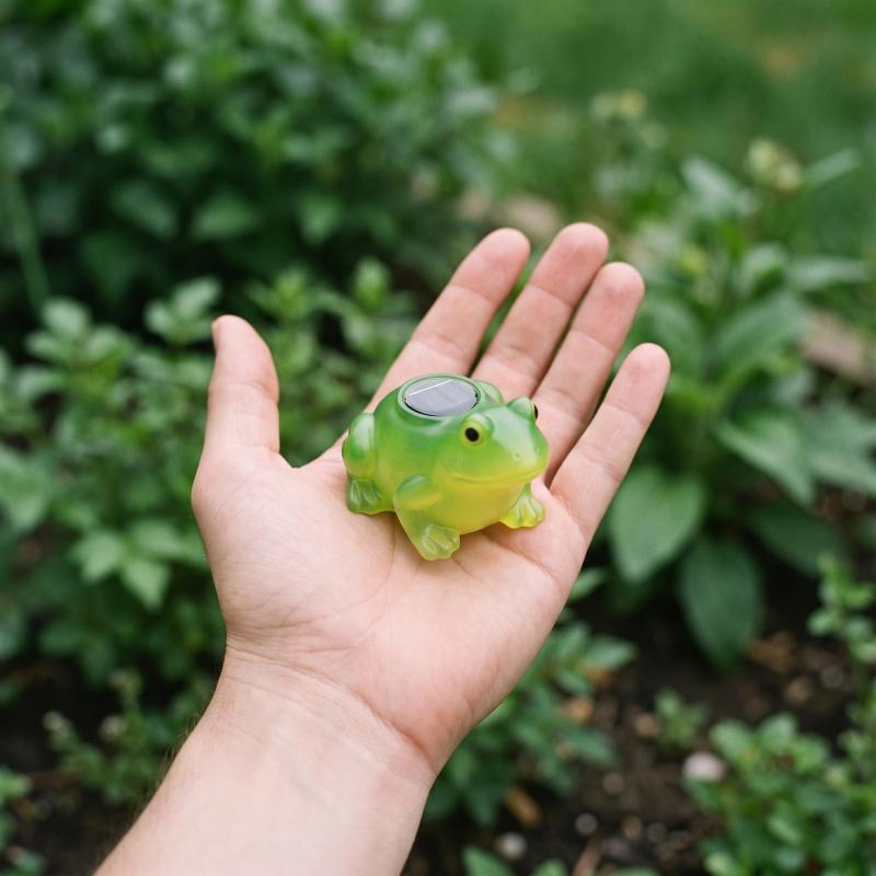 Solar frog shown in scale in a hand