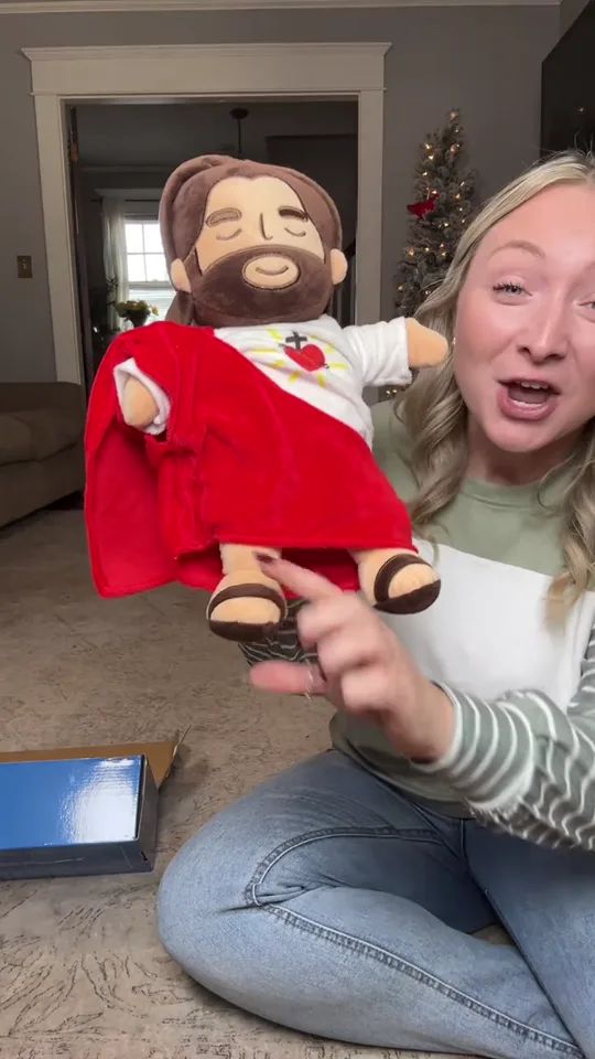 A woman opening the box and showing the plush to camera
