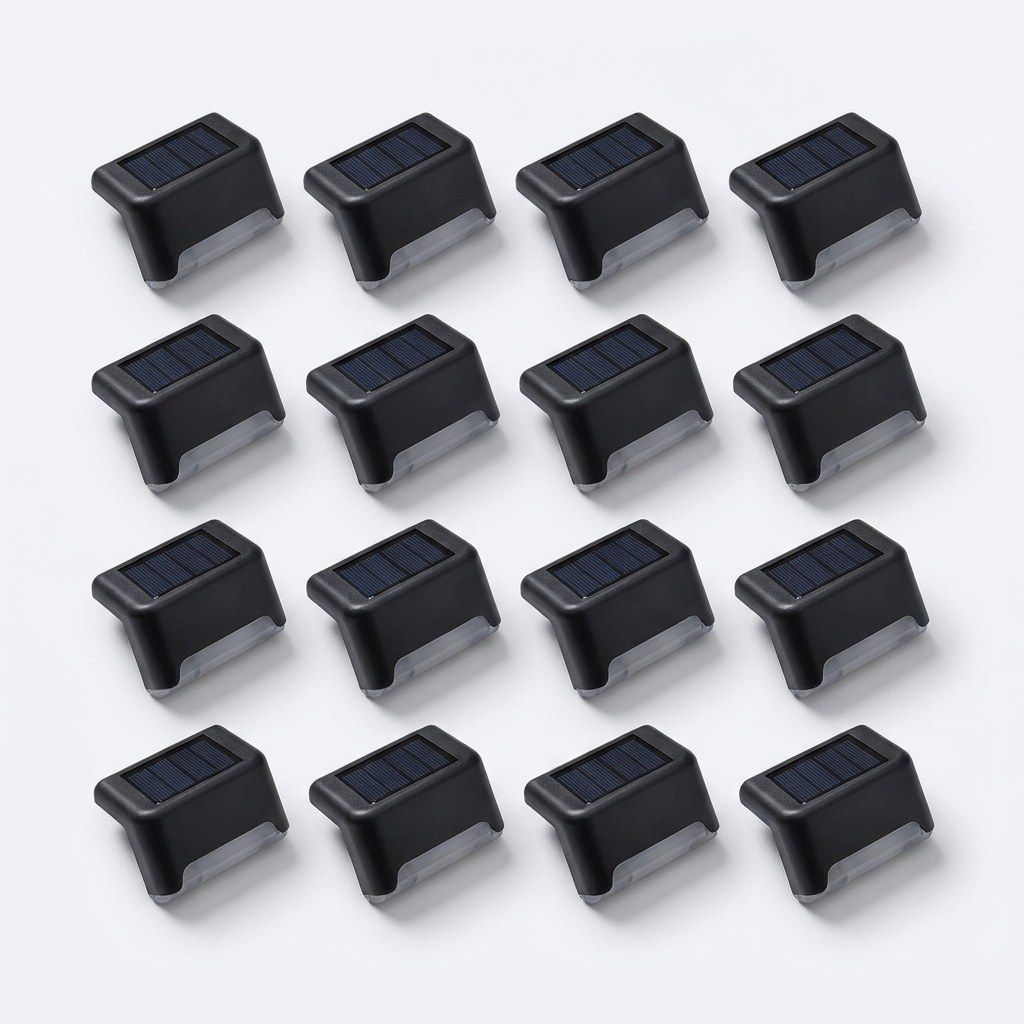 Sixteen matte-black solar deck lights laid out in a four by four grid on a white surface