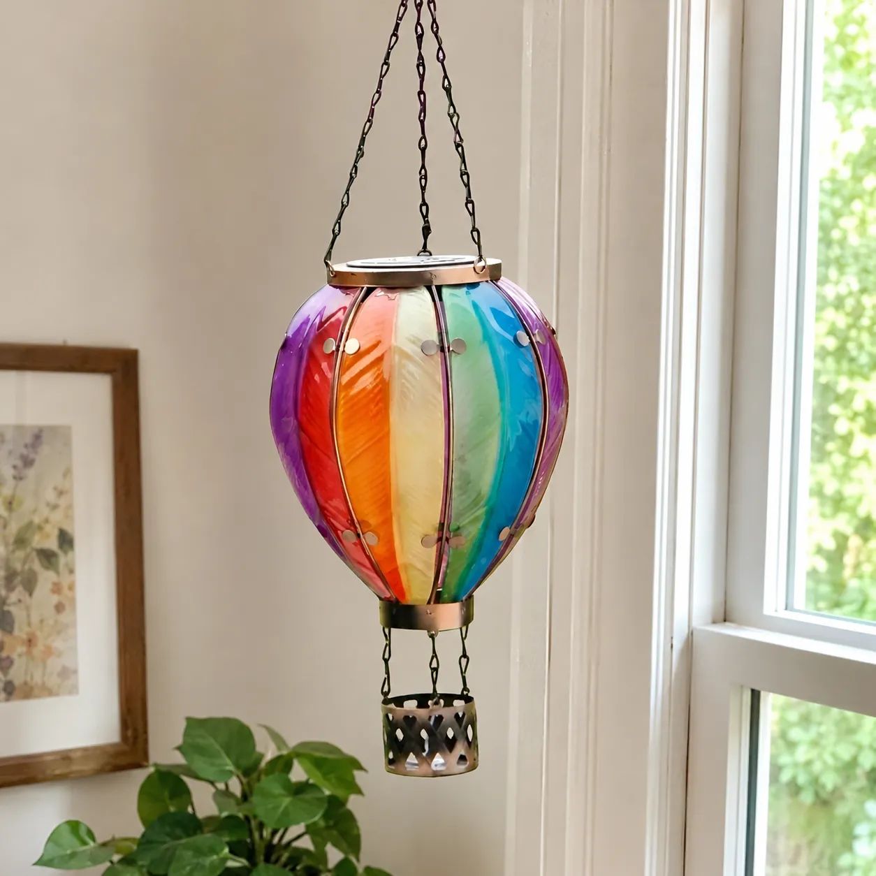 Solar hot air balloon lantern glowing warm at dusk in a garden
