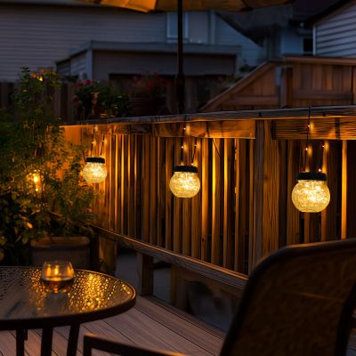 Solar lanterns glowing on a deck railing