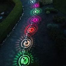 Colorful sunburst light patterns along a curved path