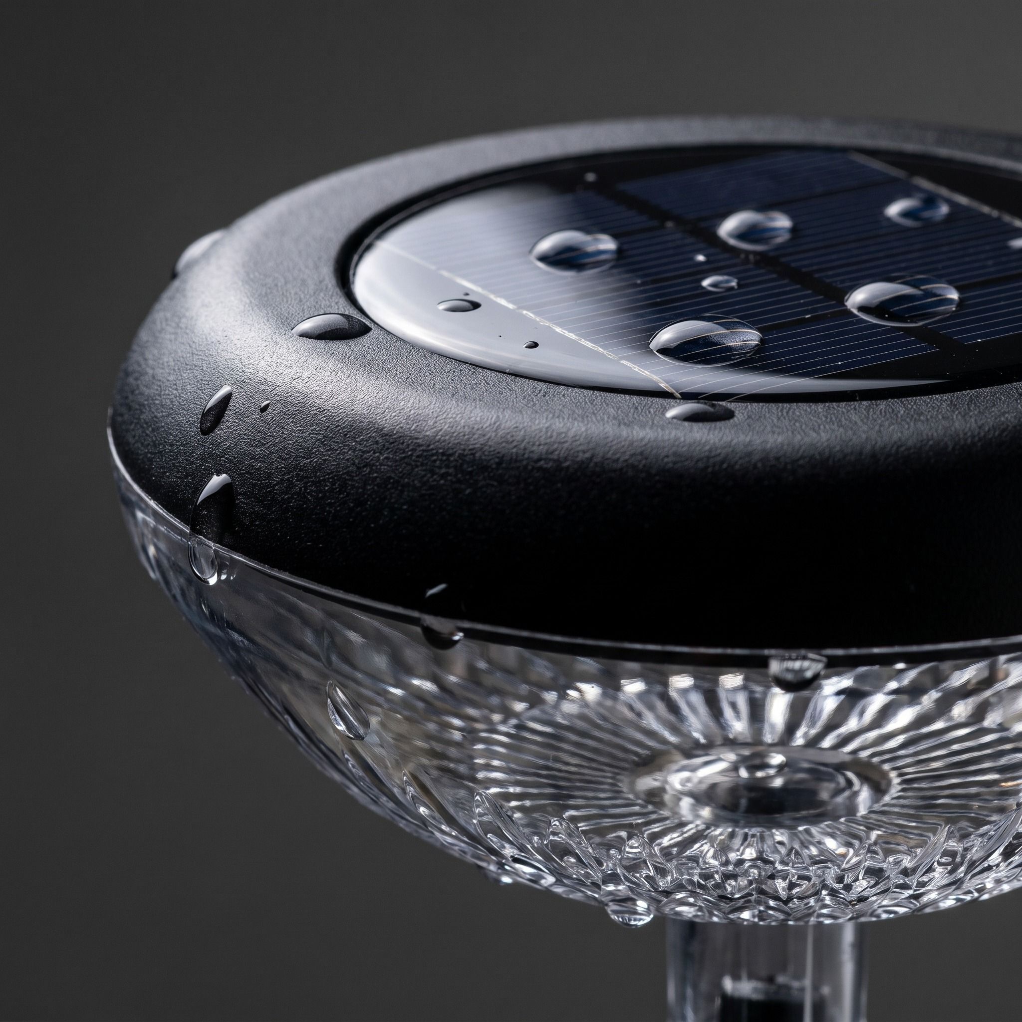 Close-up of the solar panel and textured sunflower lens with water beading on the sealed housing