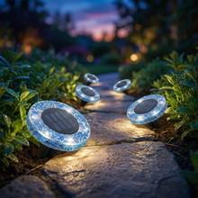 Blue circle mosaic solar disk lights on a garden path
