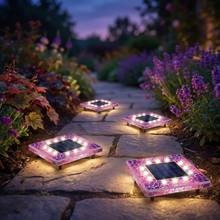 Pink square mosaic solar disk lights in a flower bed