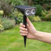 Adult hand holding the smart solar spotlight to show its real size