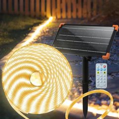 The 50 ft rope light coiled beside its solar panel and remote
