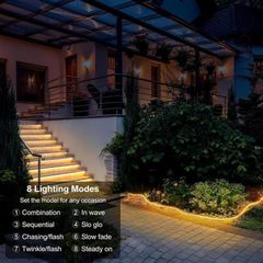 Warm rope lighting run along garden steps and a planted border at night