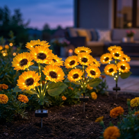Multiple solar sunflower stakes in a flower bed
