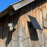 Camera and solar panel mounted on a barn wall