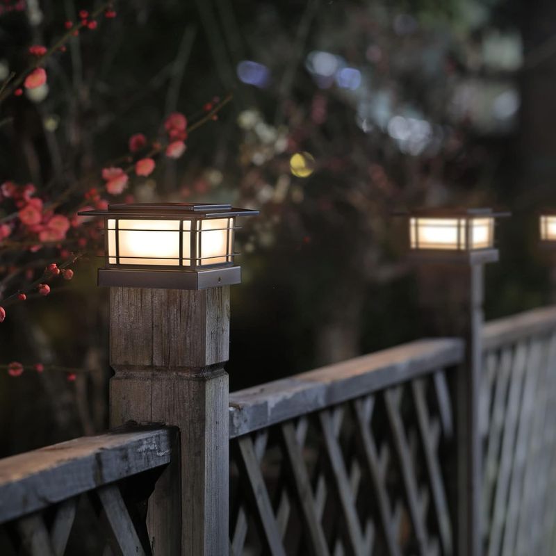 Solar Post Cap Light on a wooden fence post at dusk