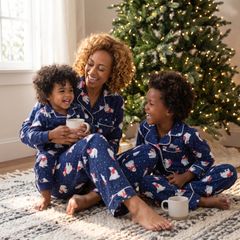 Mother and children by the tree in navy polar bear pajamas