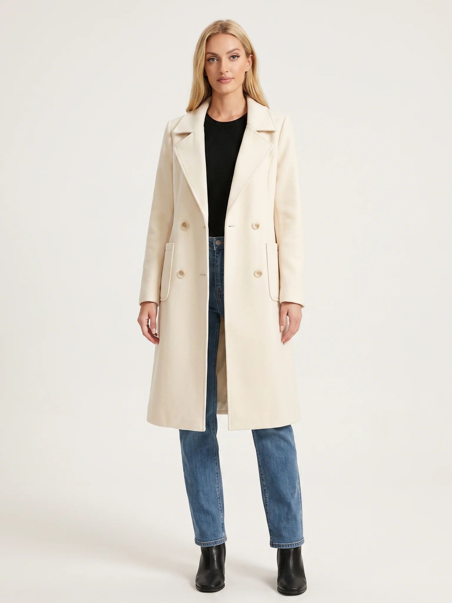 The Ivory wool-blend coat worn open on a model, photographed from the front in a studio
