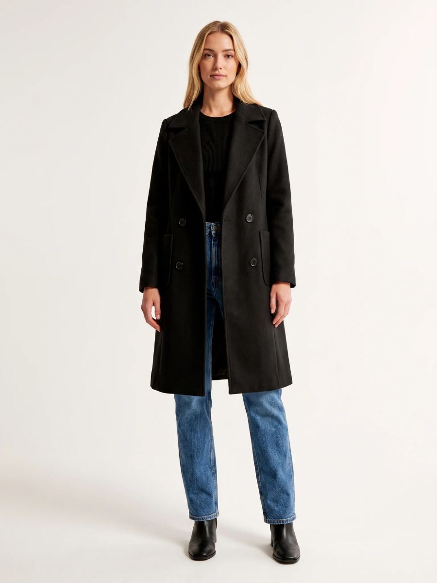 The Black wool-blend coat worn open on a model, photographed from the front in a studio