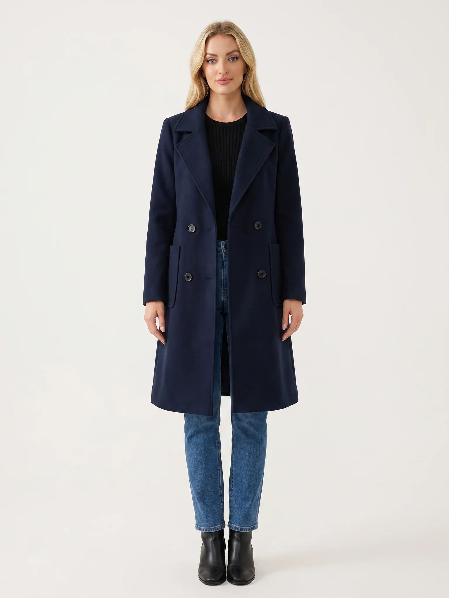 The Navy wool-blend coat worn open on a model, photographed from the front in a studio