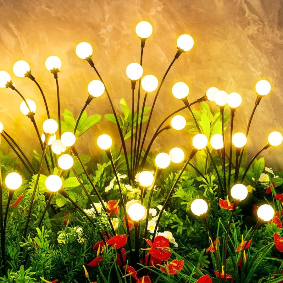 Firefly lights glowing among garden flowers